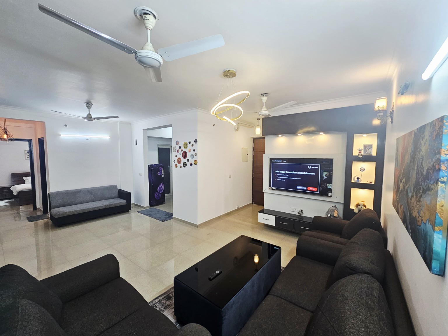 Living room and Smart TV area at Urban Nest Lucknow